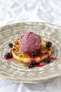 Grilled pineapple with banana and blueberry ice cream