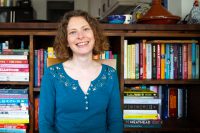 Sarah in front of bookshelves