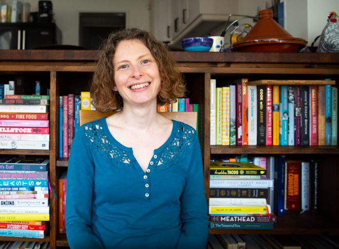 Sarah in front of bookshelves