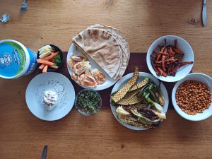 Harissa roast carrot with pomegranate glazed veg and labneh